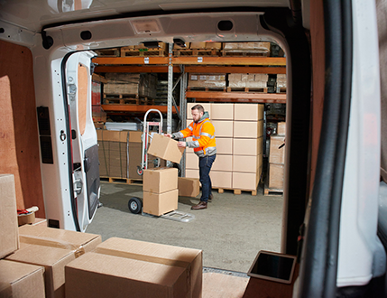 Warehouse and van, being loaded with boxes